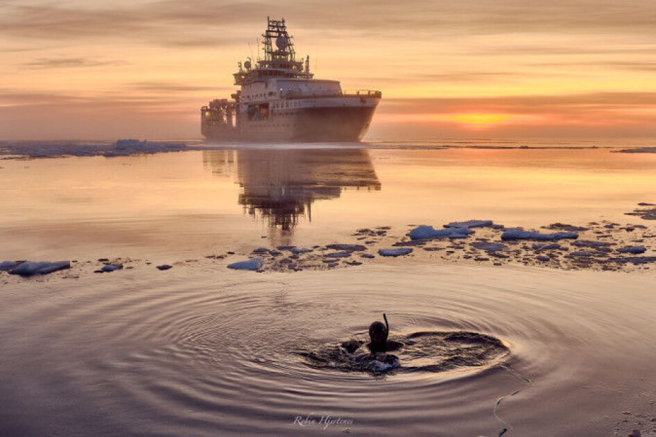 Avatar Alliance Foundation photographer Lu Lamar tests a dive suit in front of icebreaker Kronprins Haakon. The location is 4000 metres above the Aurora volcanic field.